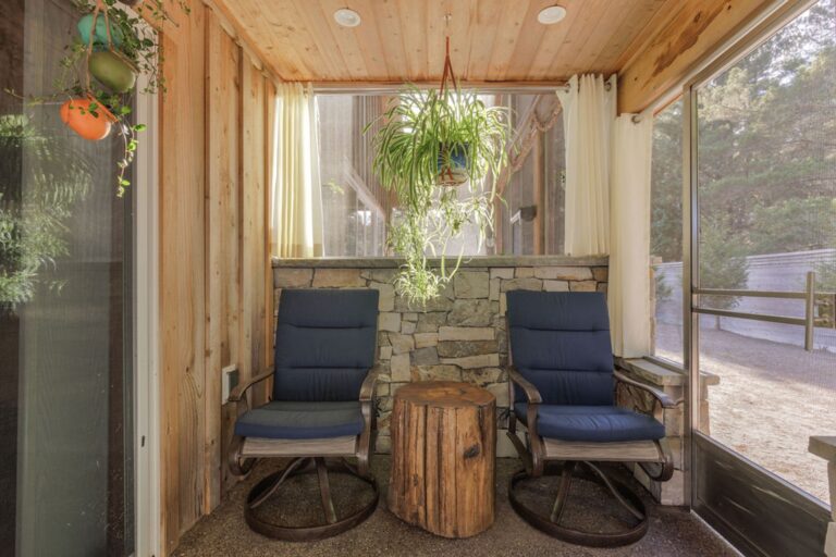 Comfortable chairs in the screen room exclusive to the downstairs master