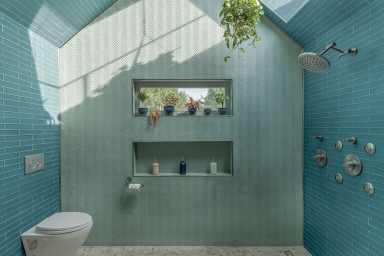 Natural light pours into this unique bathroom with heated tile floors and an over the top shower