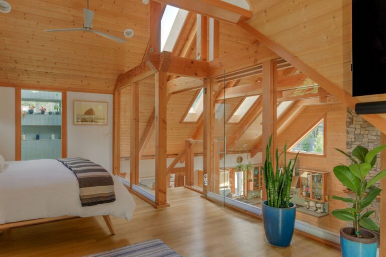 Post and beam glass wall higlights the uniqueness of this loft master suite