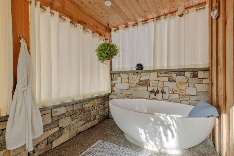 Soaker tub with body pillow. Curtains for privacy.