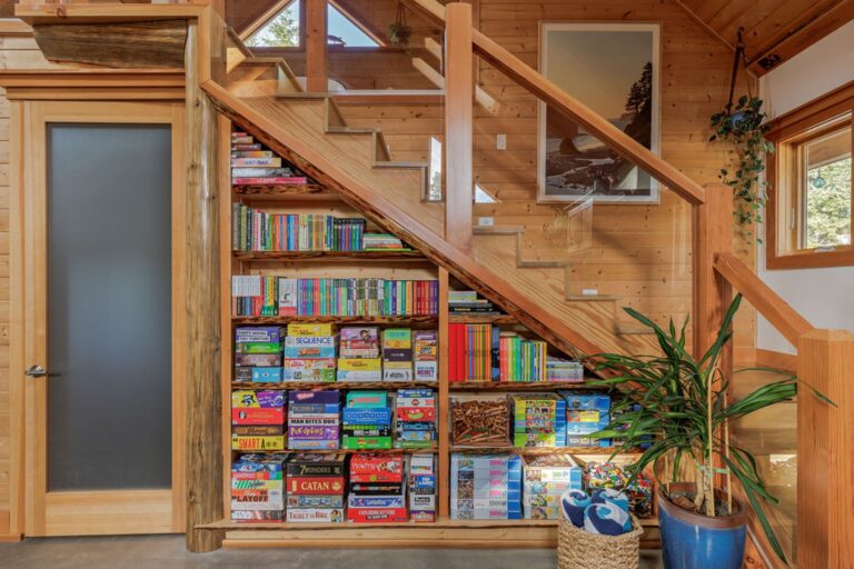 Stairs leading to upstairs master bedroom loft. Shelf underneath has a large assortment of board games, puzzles, toys, and books for all ages.