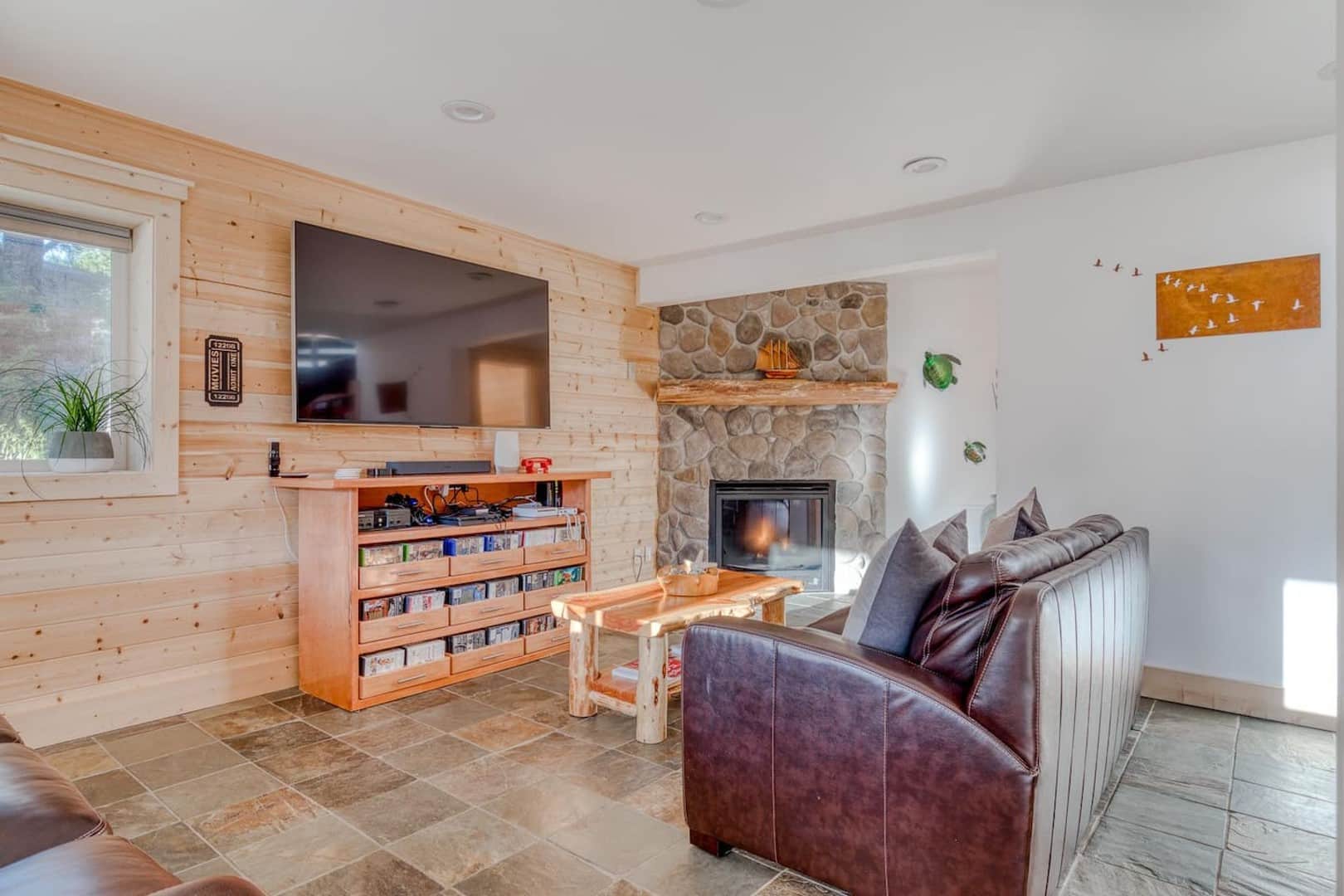 Beach Cabin - Both couches are queen sofa sleepers. Stretch out and relax by the river rock fireplace