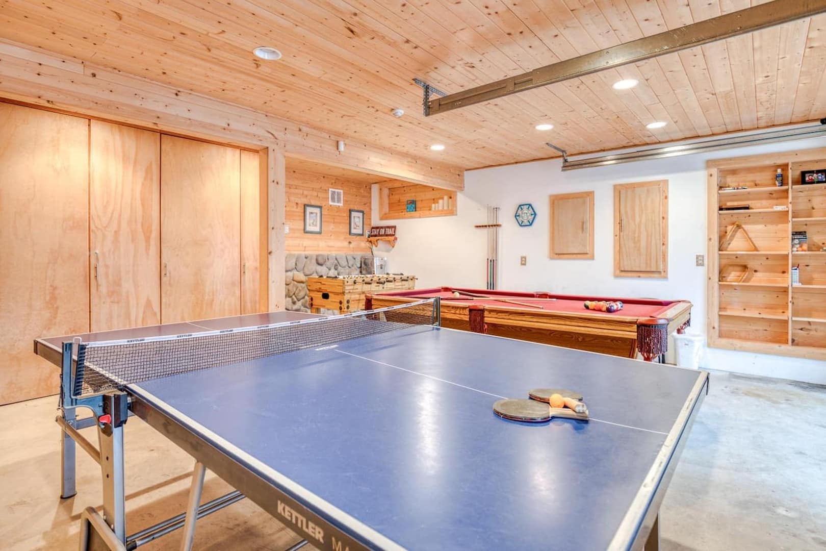 Beach Cabin - The game room has cabinets on the back wall filled with supplies for the beach and yard