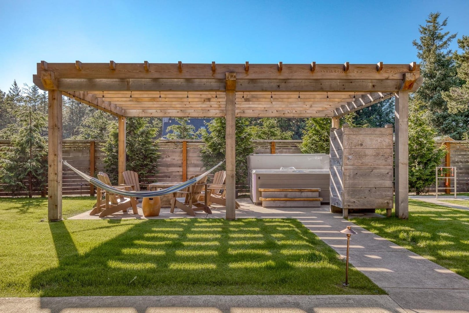 Beach Cabin - The pergola has an outdoor shower and large Hot Spring hot tub